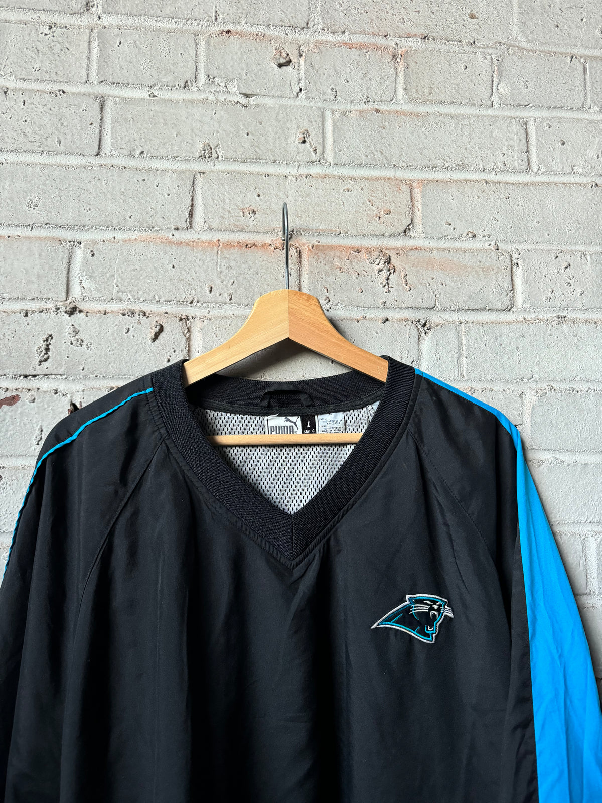 90’s Carolina Panthers Vintage Black Blue Puma Asymmetrical Sleeve Stripe Cat Scratch Font NFL Pullover Jacket (XL)