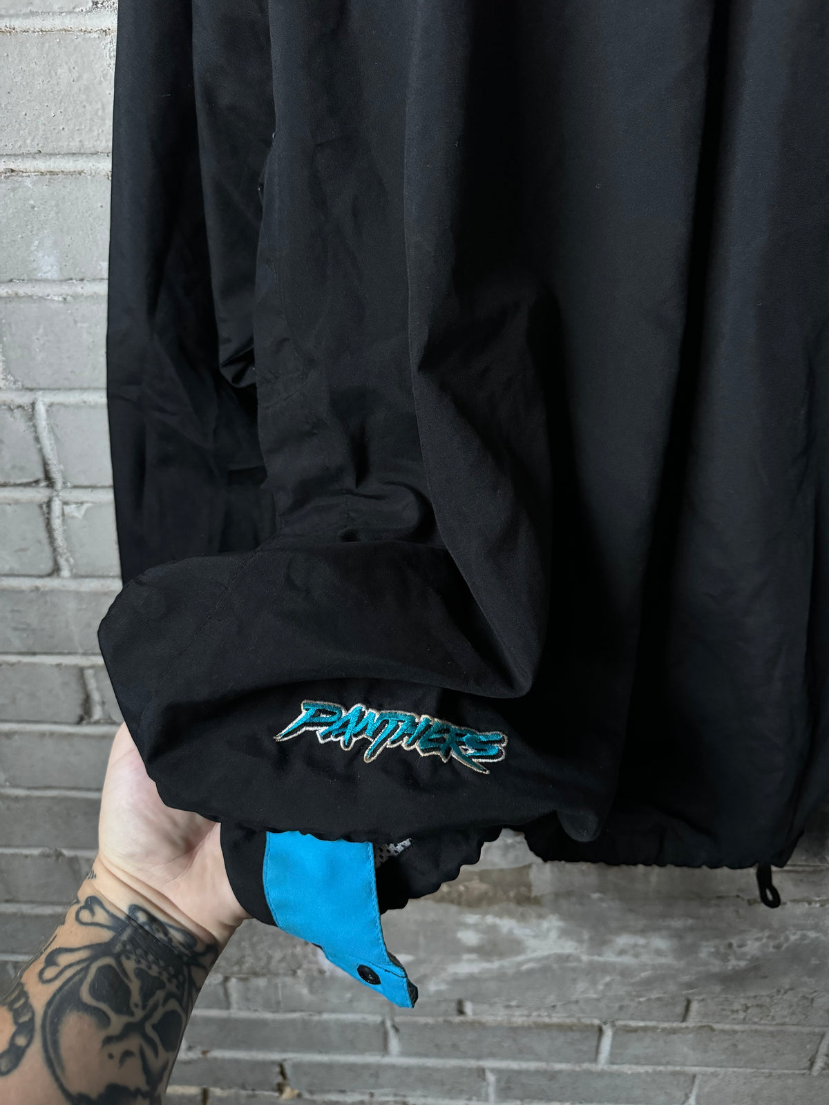 90’s Carolina Panthers Vintage Black Blue Puma Asymmetrical Sleeve Stripe Cat Scratch Font NFL Pullover Jacket (XL)