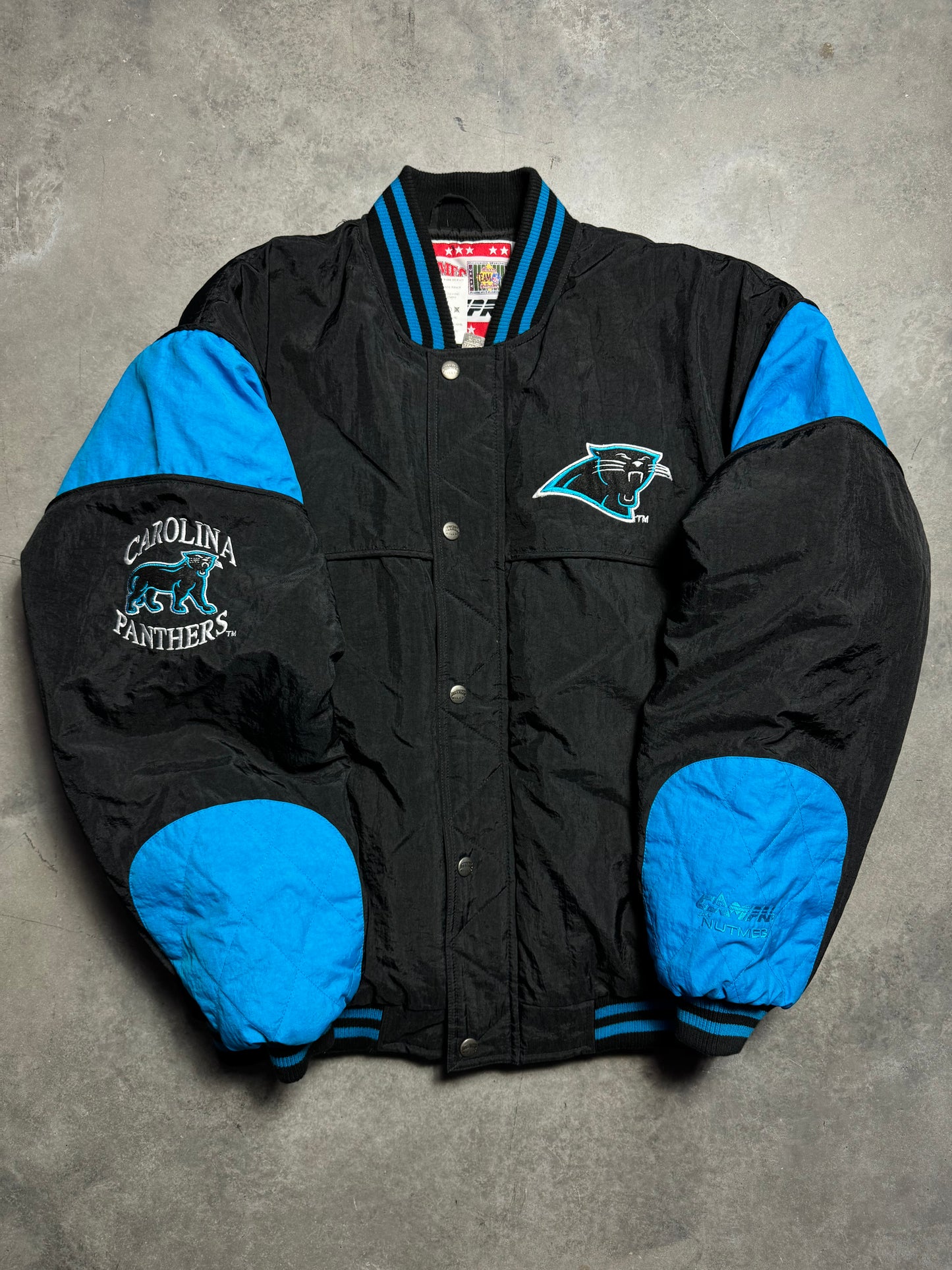 90’s Carolina Panthers Vintage Black Nutmeg Mills Campri Full Cat Alternate Logo NFL Quilted Bomber Nylon Jacket (XL)