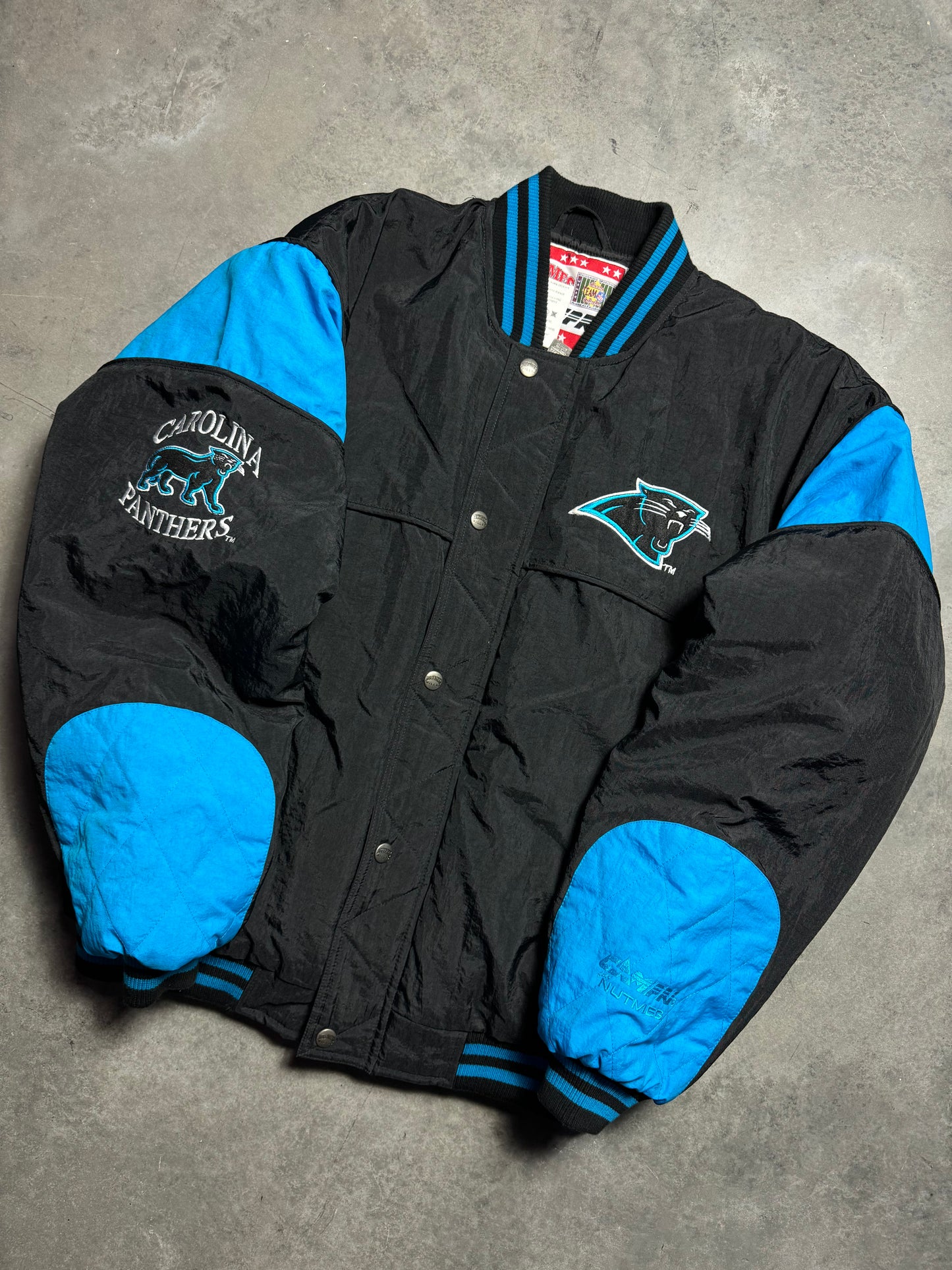 90’s Carolina Panthers Vintage Black Nutmeg Mills Campri Full Cat Alternate Logo NFL Quilted Bomber Nylon Jacket (XL)