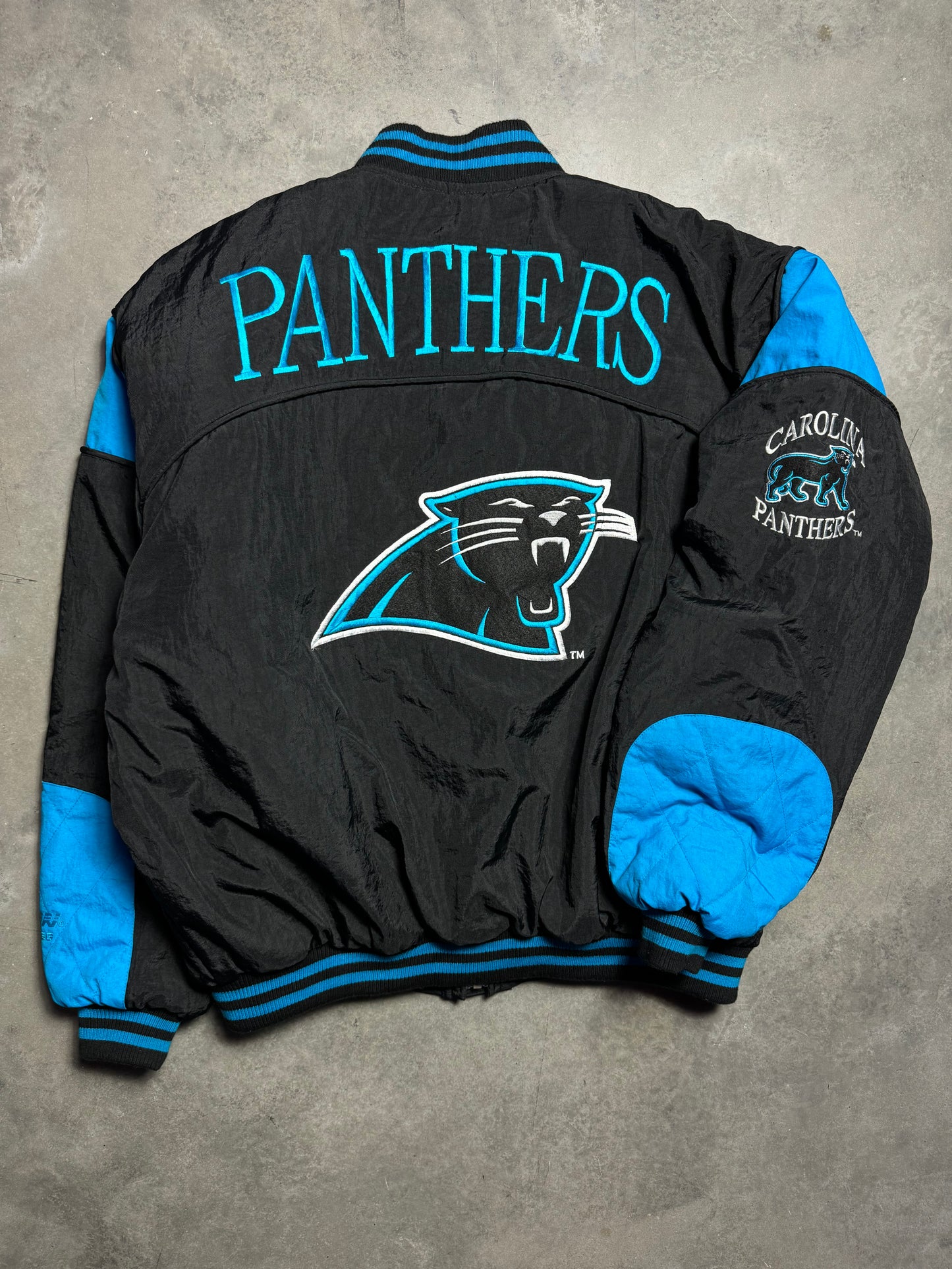90’s Carolina Panthers Vintage Black Nutmeg Mills Campri Full Cat Alternate Logo NFL Quilted Bomber Nylon Jacket (XL)
