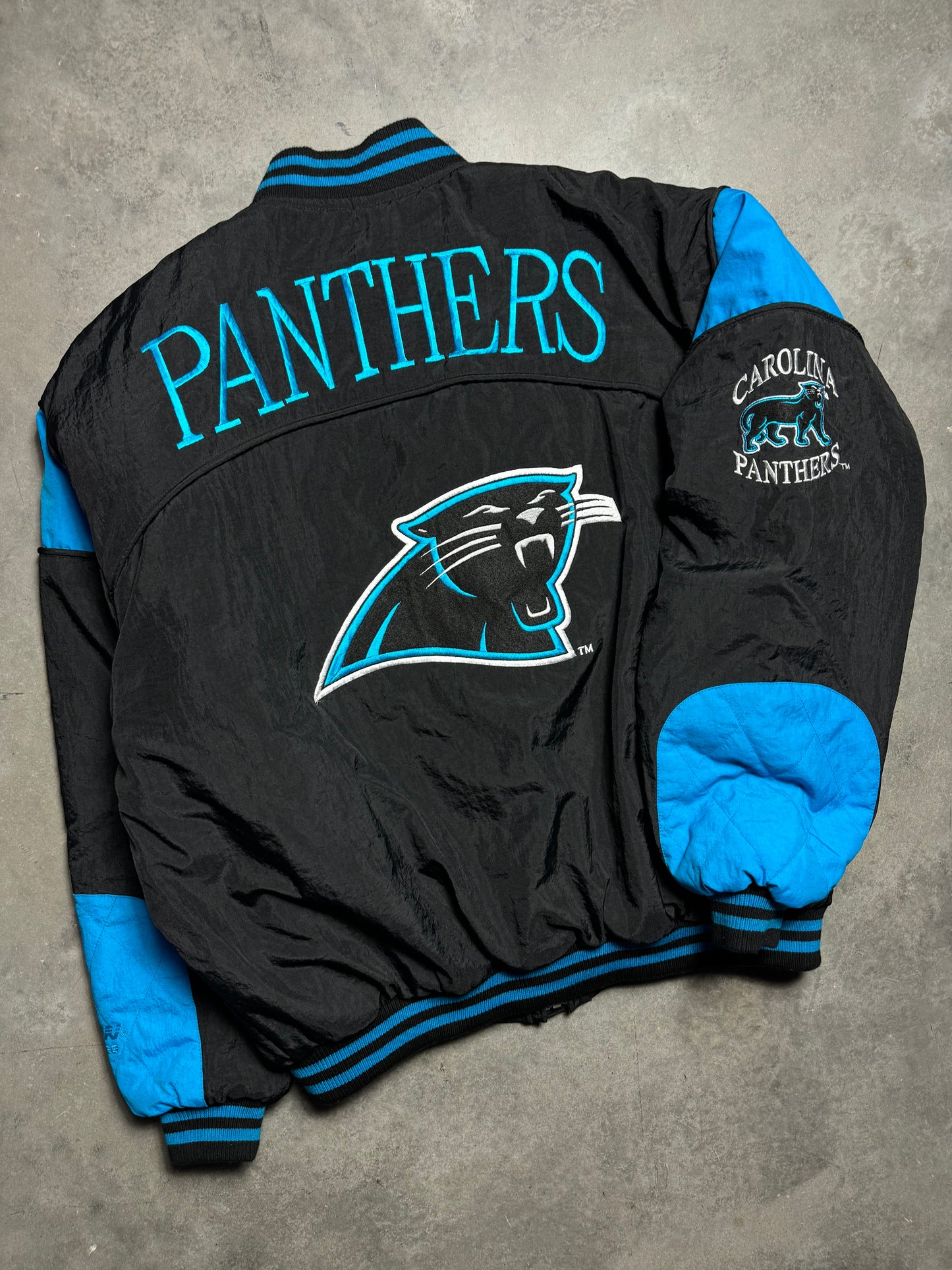 90’s Carolina Panthers Vintage Black Nutmeg Mills Campri Full Cat Alternate Logo NFL Quilted Bomber Nylon Jacket (XL)