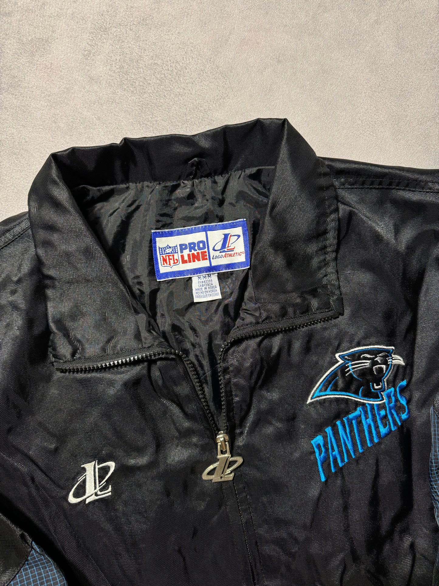 90’s Carolina Panthers Vintage Black Logo Athletic Multi Logo Embroidered NFL Windbreaker Jacket (Medium)