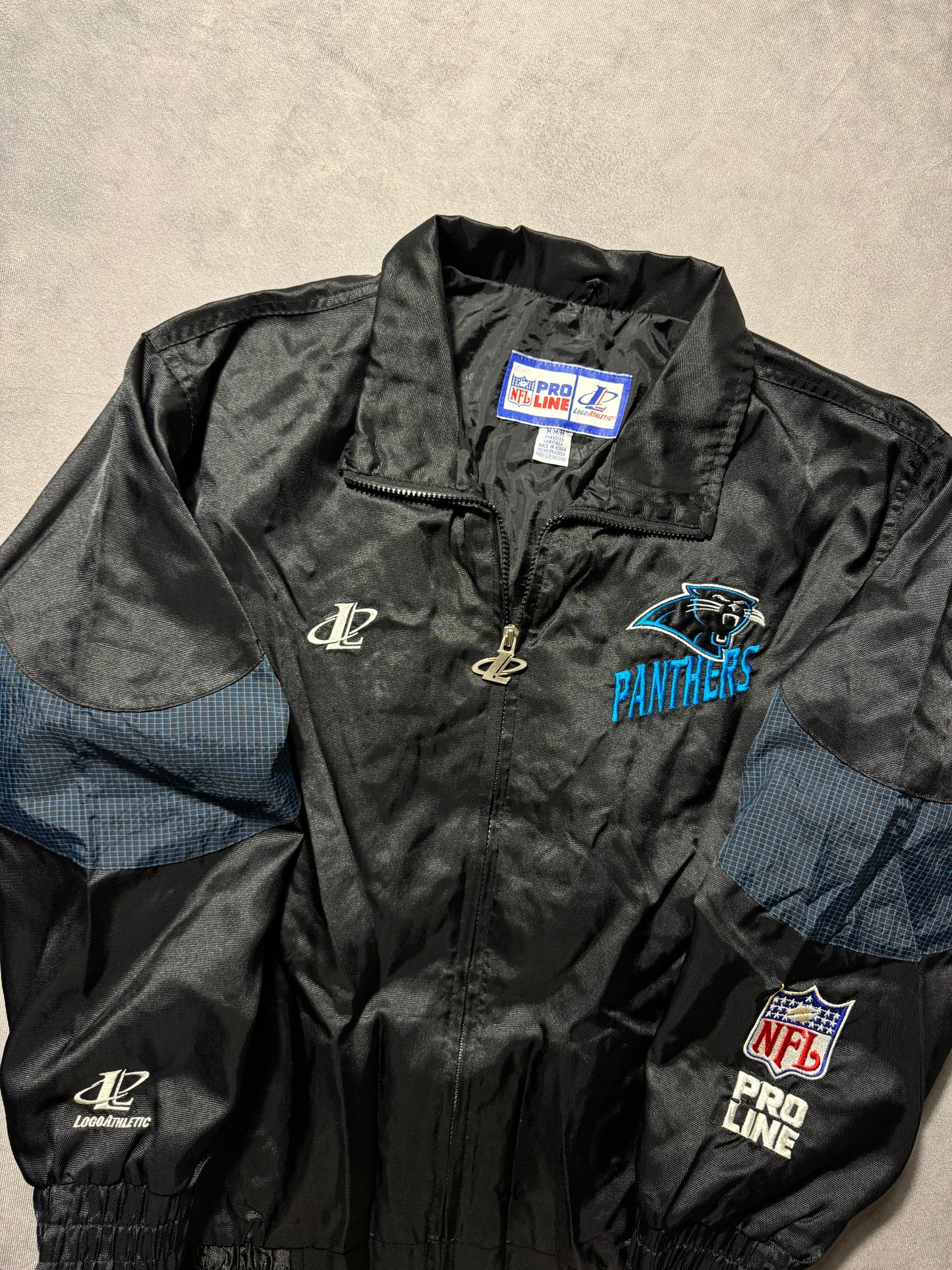 90’s Carolina Panthers Vintage Black Logo Athletic Multi Logo Embroidered NFL Windbreaker Jacket (Medium)